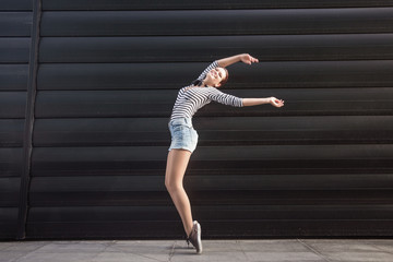 Young happy woman standing outdoors