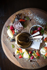 sharing pudding plate with berries, brownie and meringue