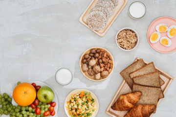 Healthy breakfast ingredients on black concrete background. Oat flakes, almond milk, nuts, fruits and berries. Healthy lifestyle, dieting, healthy eating concept