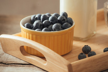 Healthy vegan breakfast. Bottled milk with chia, almond, fresh fruit and berries over wooden table background, copy space. Clean eating, weight loss, vegetarian, raw food concept