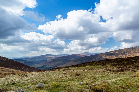 Beautiful scenic mountain landscape with clouds against the horizon in Wicklow mountains Ireland.
