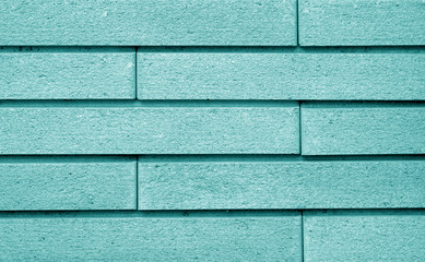 Decorative brick wall in cyan color.