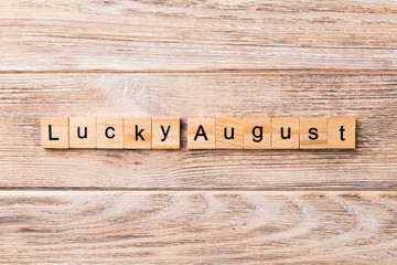 lucky august word written on wood block. lucky august text on table, concept