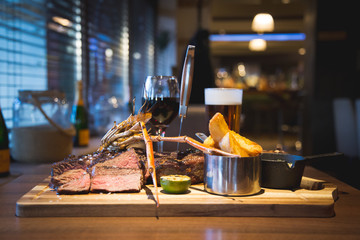 surf n turf with chips. Glass of red wine and pint of beer