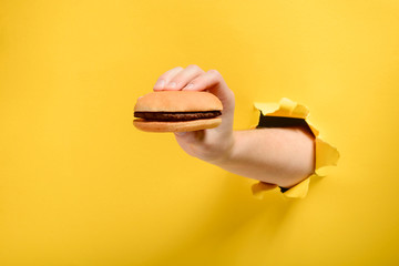 Hand holding a hamburger
