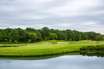 Fototapeta na wymiar Mirror lake, lawn for golfing on golf course