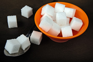 Sugar cubes in a bowl and tea spoon