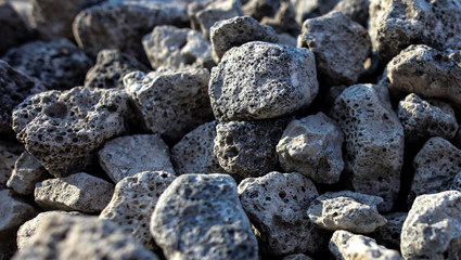 Stones on the edge of the asphalt road