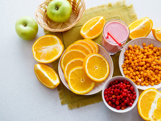 Sliced juicy oranges and berry cocktail on the table. View from above
