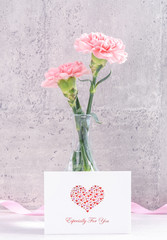 Mothers day handmade giftbox surprise wishes photography - Beautiful blooming carnations with pink ribbon box isolated on gray wallpaper design, close up, copy space, mock up