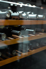 Storing bottles of wine in fridge. Alcoholic card in restaurant. Cooling and preserving wine.
