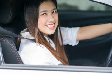close up young asian woman driving in eco car for travel concept