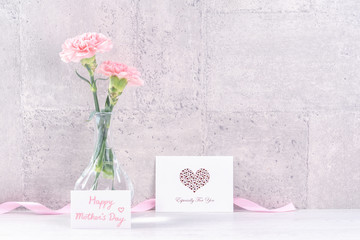 Mothers day handmade giftbox surprise wishes photography - Beautiful blooming carnations with pink ribbon box isolated on gray wallpaper design, close up, copy space, mock up