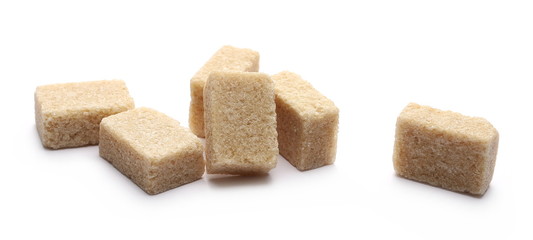 Brown cane sugar cubes isolated on white background