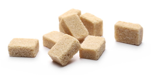 Brown cane sugar cubes isolated on white background