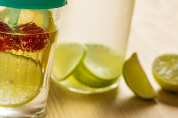 citrus soda and pieces of lemon on wooden table