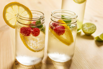 Cold soda in glass jar with lemon and berries