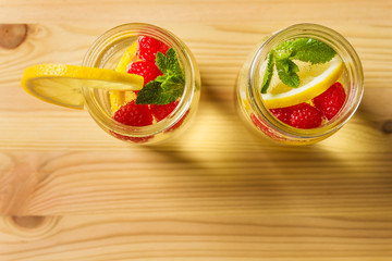 flat lay of lemonade with berries on wooden table