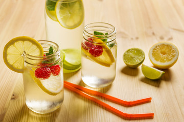 soft drinks with lemon and berries on wooden table