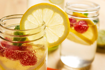 Fototapeta na wymiar Summer soda with lemon and berries in glass jar