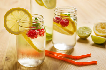soda with lemon and berries on wooden table