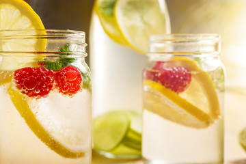 Cold summer soda with lemon and berries in jar