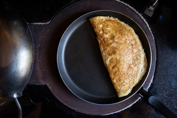 omelette cooking on a stove cooker 