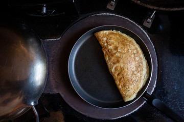 omelette cooking on a stove cooker 