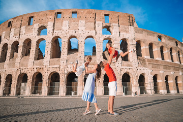 Happy family in Rome over Coliseum background.