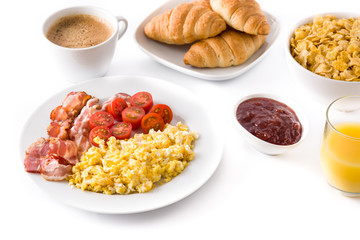 Breakfast with scrambled eggs, bacon, tomatoes,coffee,orange juice ,croissant and corn flakes isolated on white background. Close up
