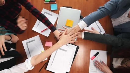 Business concept. A working team put their hands together