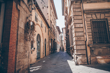 Old beautiful empty narrow streets in small city of Lucca in Italy