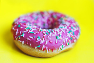 pink donut on a yellow background close