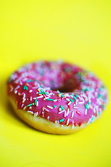 pink donut on a yellow background close
