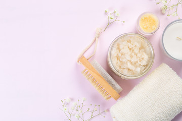 SPA concept - towel, salt, candle on pink background, copy space