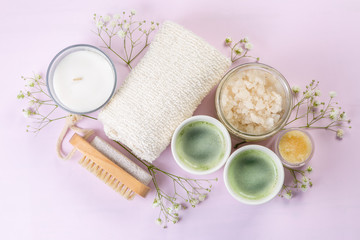 SPA concept - towel, salt, candle on pink background, copy space