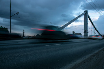 Fototapeta na wymiar Traffic on the bridge in the evening