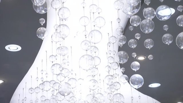 a lot of modern beautiful clear glass ceiling lights on a modern ceiling