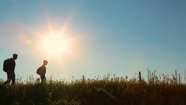 Portrait of cute funny cheerful family of father and his little son having adventure outside together. Man and boy cheerfully waving their hands into camera as hello or goodbye sign. Happy travelling