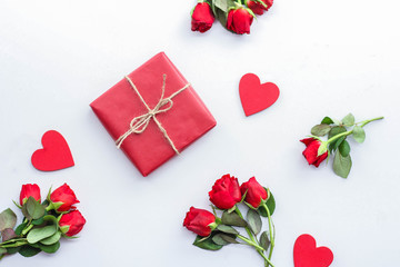 Beautiful roses and gift box on light background