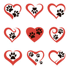 collection of dog or cat footprints in abstract red heart isolated on white background © Alexkava