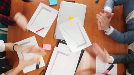 Business concept. A working team sitting at the conference and clapping their hands