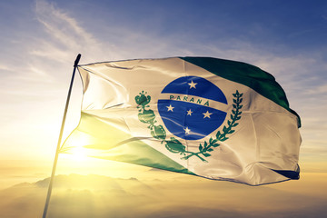 Parana state of Brazil flag waving on the top sunrise mist fog - obrazy, fototapety, plakaty