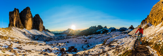 View of cyclist riding mountain bike on trail in Dolomites,Tre Cime di Laverado, South Tirol, Italy
