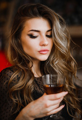 Portrait of a tender woman holding a glass of wine in her hand