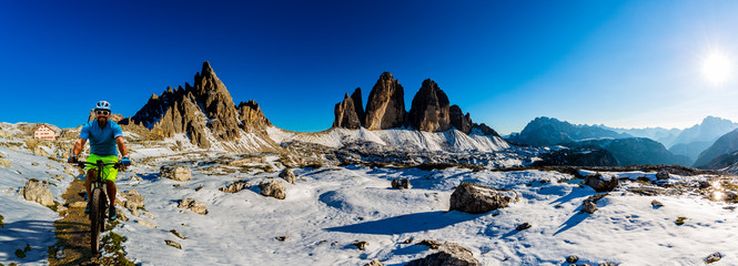 View of cyclist riding mountain bike on trail in Dolomites,Tre Cime di Laverado, South Tirol, Italy