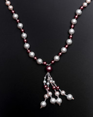 Pearl necklace on black background