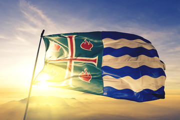 Mayaguez municipality of Puerto Rico flag waving on the top sunrise mist fog