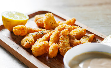 Fried Shrimp with sauce and lemon on wooden table background