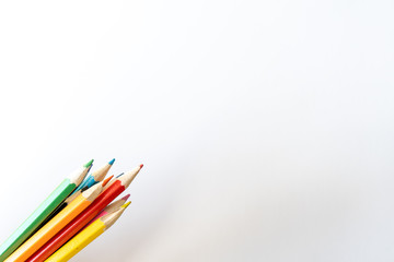 Bunch of colored pencils for child art on white background